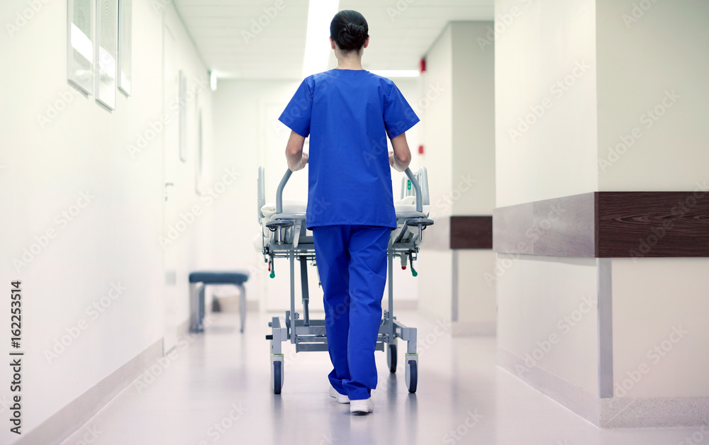 nurse carrying hospital gurney to emergency room nurse carrying hospital gurney to emergency room