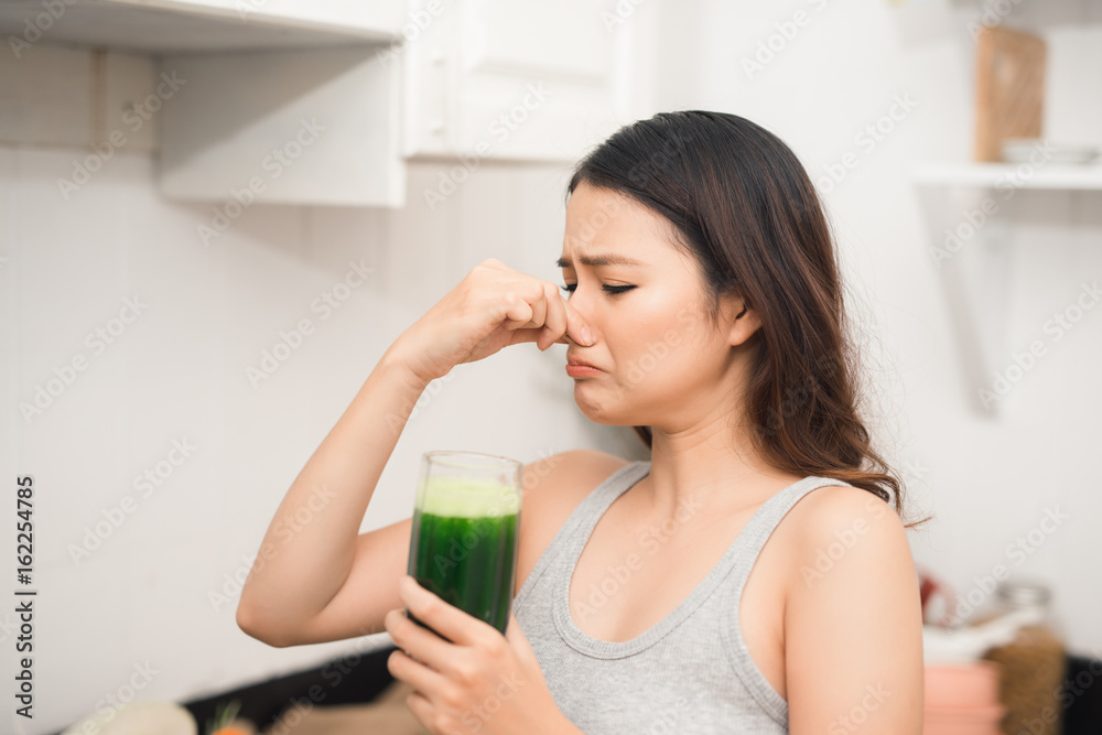 Young asian woman enjoy healthy vegetarian smoothie for weight loss and detox Young asian woman enjoy healthy vegetarian smoothie for weight loss and detox