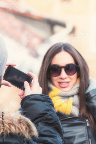 Young couple doing selfie in urban surroundings.