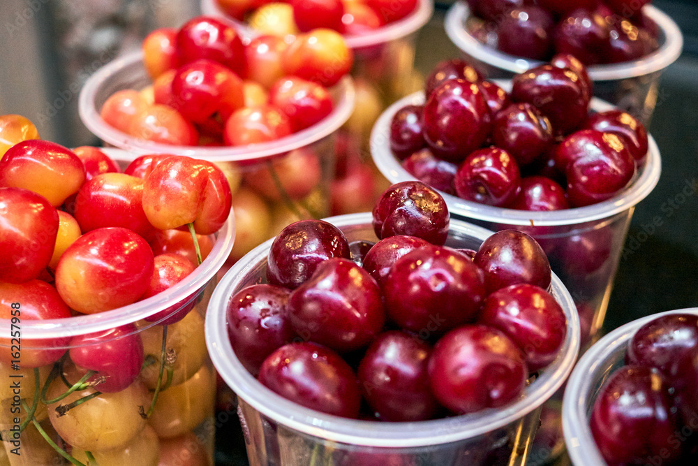 Cherry red and yellow in plastic glasses light Cherry red and yellow in plastic glasses light