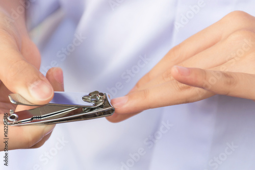 Long finger nails. It's time to cut with a nail clipper. photo