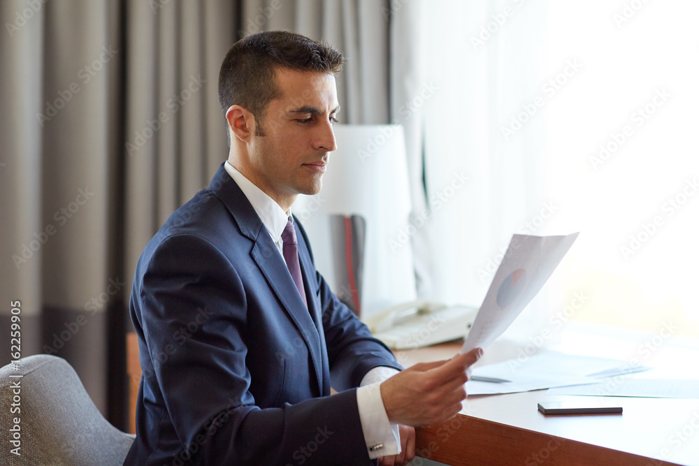 businessman with papers working at hotel room businessman with papers working at hotel room