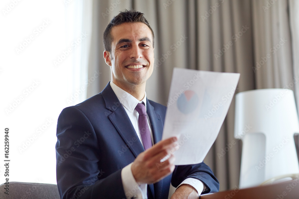 businessman with papers working at hotel room businessman with papers working at hotel room