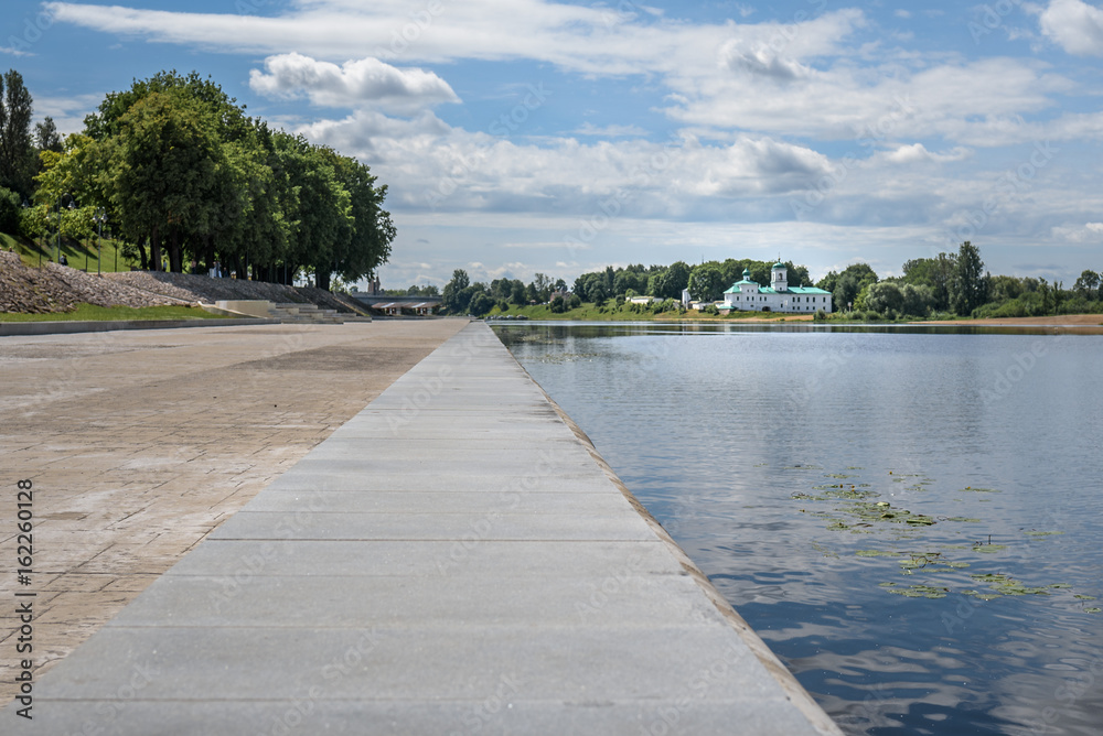 Pskov, summer promenade on the background of the river and the Mirozhsky monastery