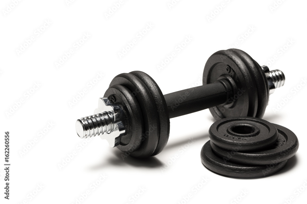 close up of iron dumbbell with weight plates isolated on white