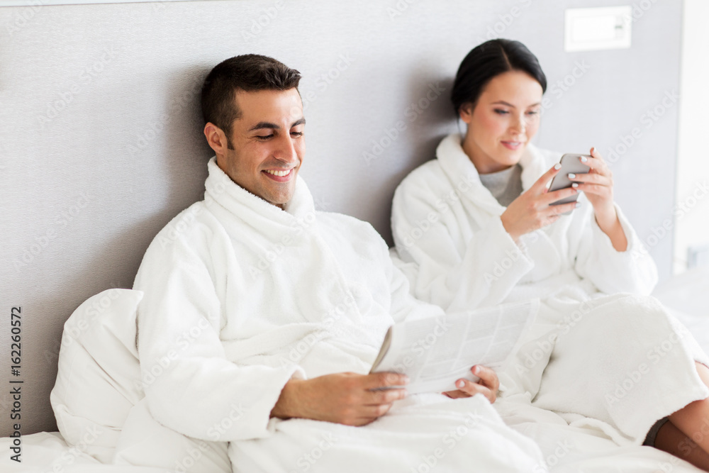 happy couple in bed at home or hotel room happy couple in bed at home or hotel room