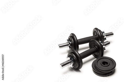 black iron dumbbells with weight plates isolated on white
