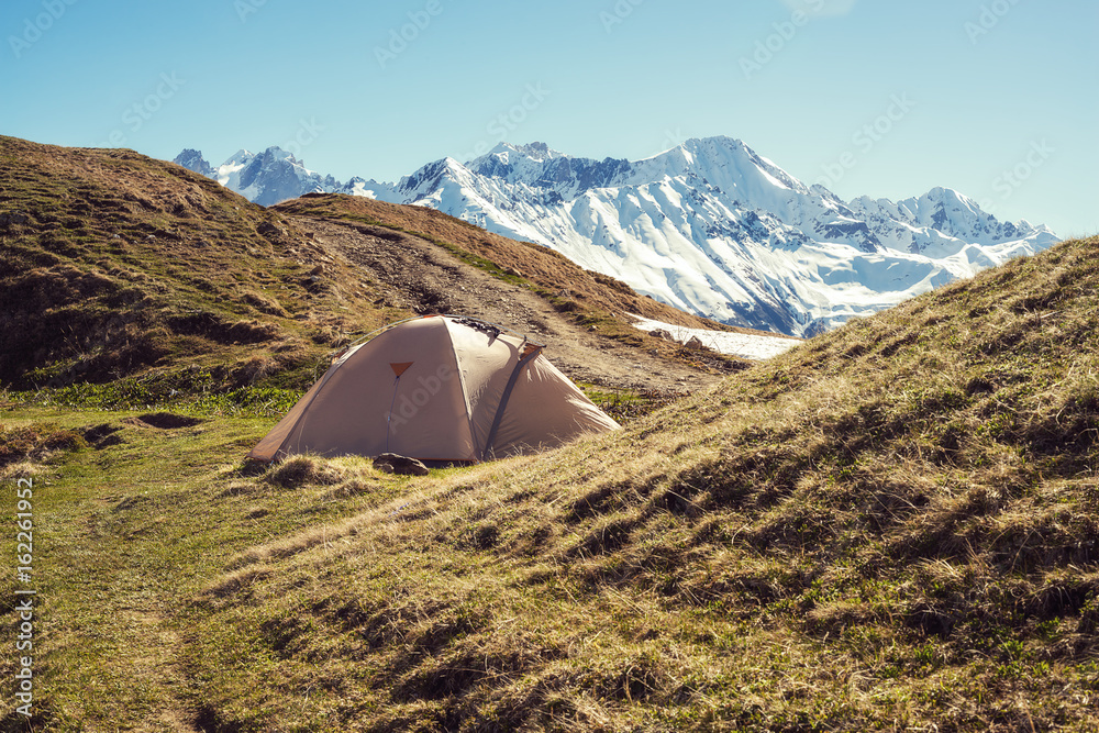Camp in the mountains - a tent on a plateau