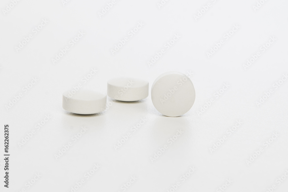 white pills on white background white pills on white background