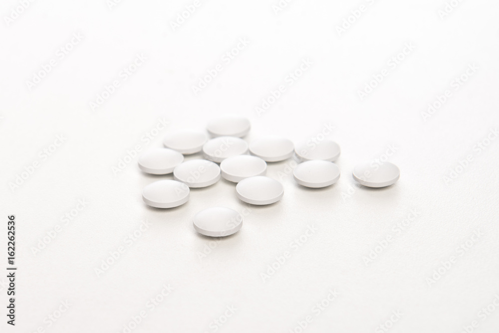 white pills on white background