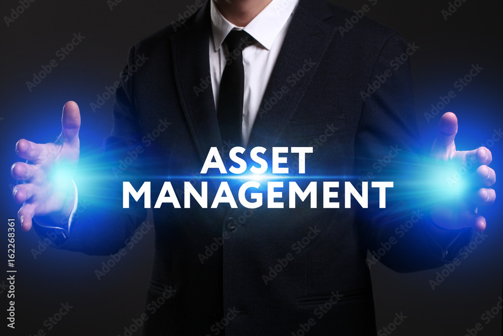 Business, Technology, Internet and network concept. Young businessman working on a virtual screen of the future and sees the inscription: Asset management Business, Technology, Internet and network concept. Young businessman working on a virtual screen of the future and sees the inscription: Asset management