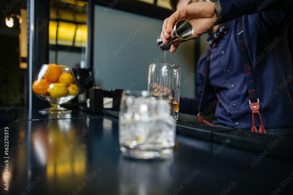 Bartender is making cocktail at bar. Bartender is making cocktail at bar.