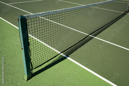 Tennis net in sunshine on all weather tennis court   © Lance Bellers
