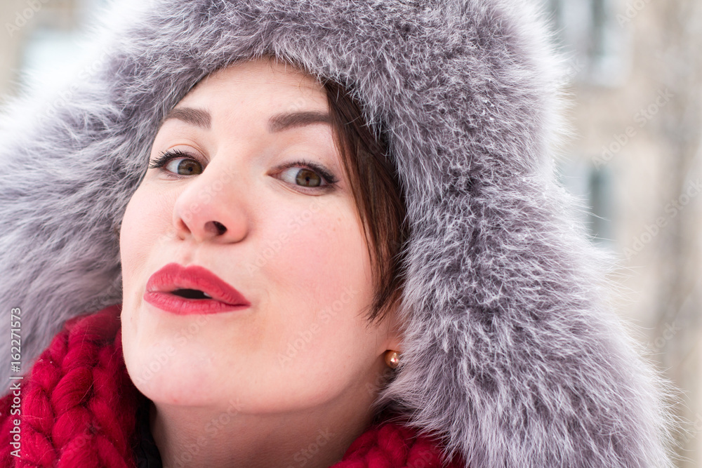 Cute girl in a warm hat in winter Cute girl in a warm hat in winter