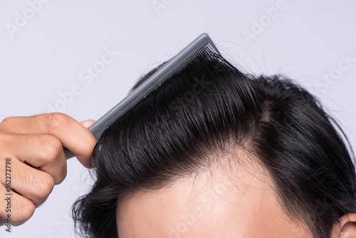 Close up photo of clean healthy man's hair. Young man comb his hair