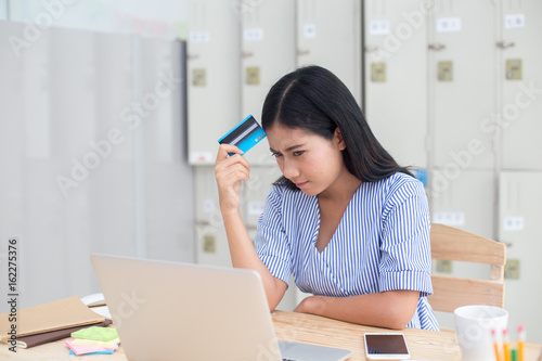 Beautiful asian women using craditcard for shopping online with laptop, online shopping protrait concept. photo