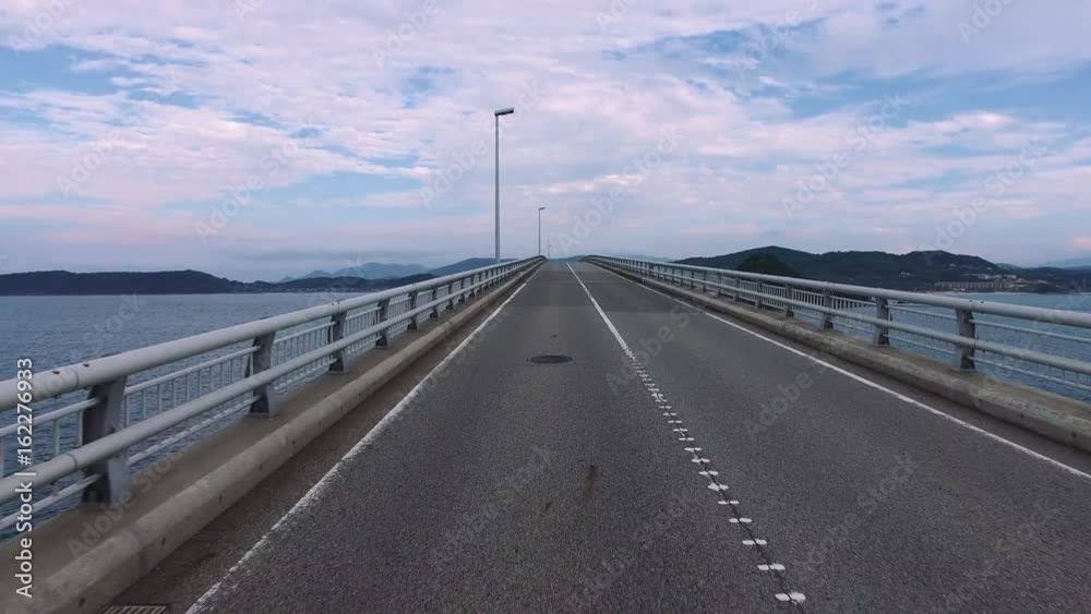 Driving shot of empty, straight road over ocean “Tsunoshima bridge”
Driving shot of empty, straight road over ocean “Tsunoshima bridge”