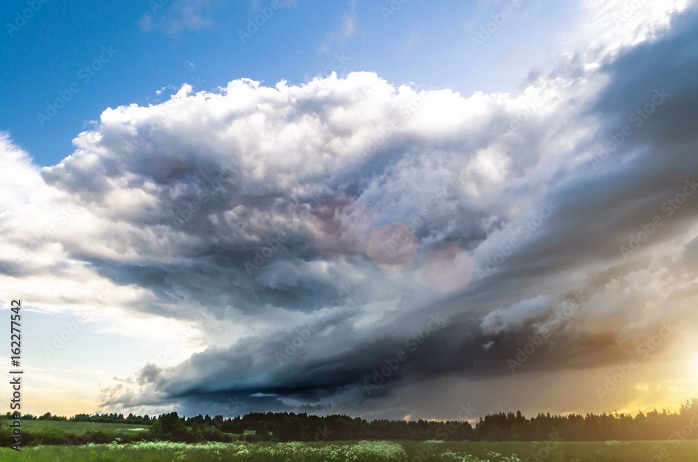 Supercell thunderstorm sunset and the blue sky and cirrus clouds.