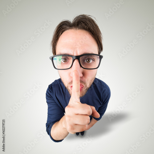 Man say Shh with hand gesture photo