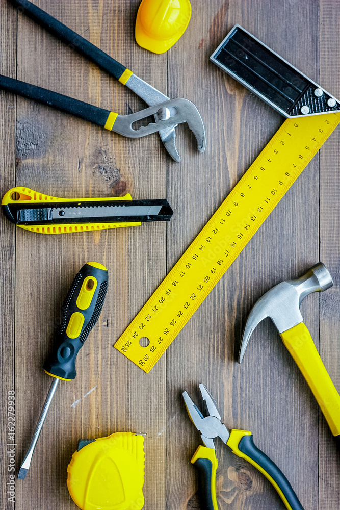Preparing for appartment repair. Set of construction tools on wooden table background top view Preparing for appartment repair. Set of construction tools on wooden table background top view