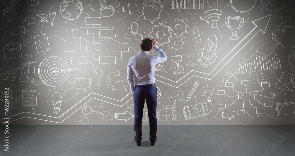 Businessman watching a project sketch on a wall 3D rendering Businessman watching a project sketch on a wall 3D rendering