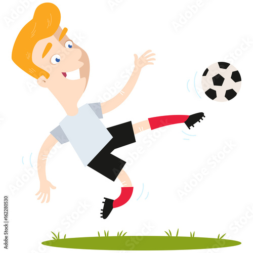 Smiling blond caucasian cartoon football player wearing red shirt and blue shorts kicking football in mid-air isolated on white background