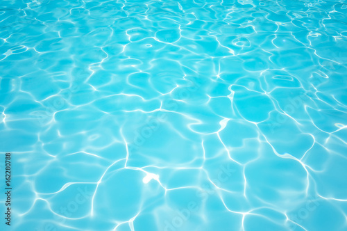 Blue and bright ripple water and surface in swimming pool , Beautiful motion gentle wave in pool © peangdao