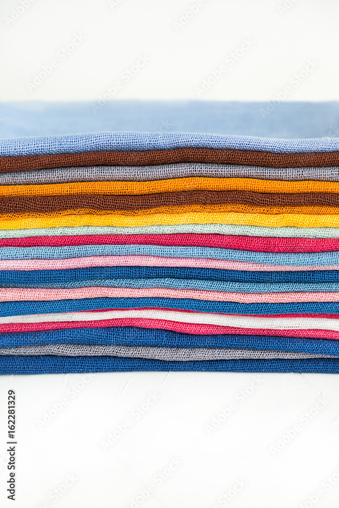 Closed up view of a pile of colorful cotton fabric. Store or market concept,