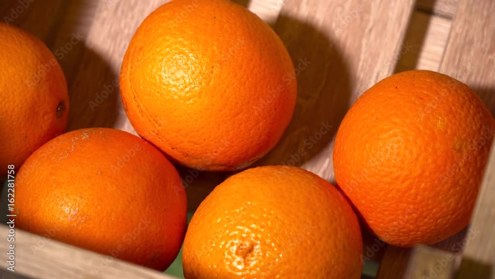 Fresh oranges in the wooden box closeup Fresh oranges in the wooden box closeup