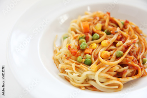 Fettuccine pasta in tomato sauce isolated in white background