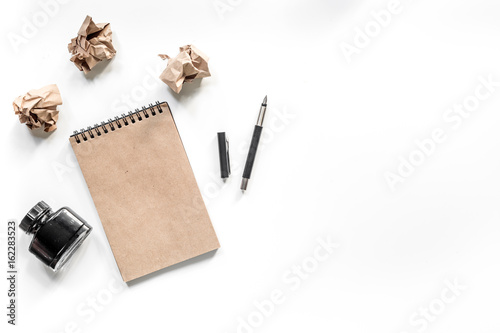 Writer concept. Vintage notebook, pen and crumpled paper on white background top view copyspace mockup