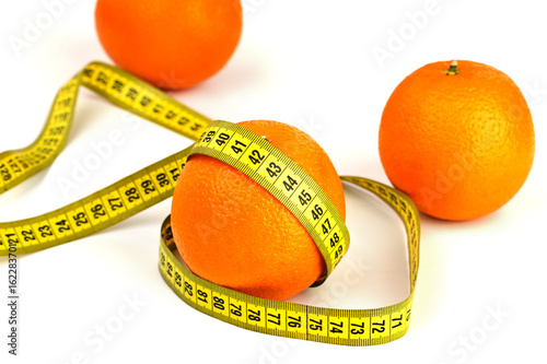 ripe oranges and tape measure