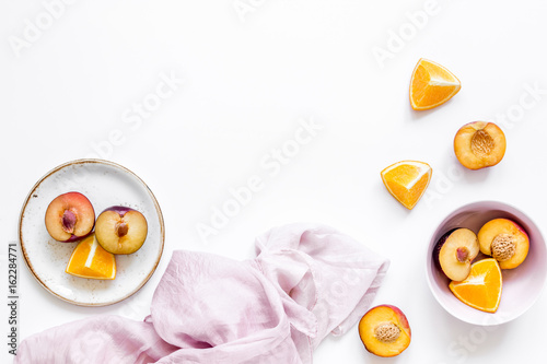 napkin, cut peach and orange for exotic fruit on white background top view mockup