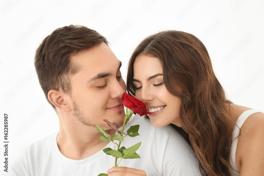 Beautiful couple with rose on light background Beautiful couple with rose on light background