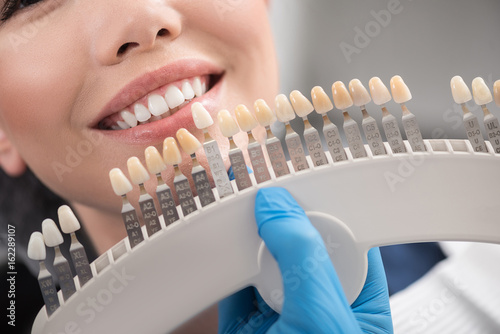 Teeth implant enclosing to happy female mouth