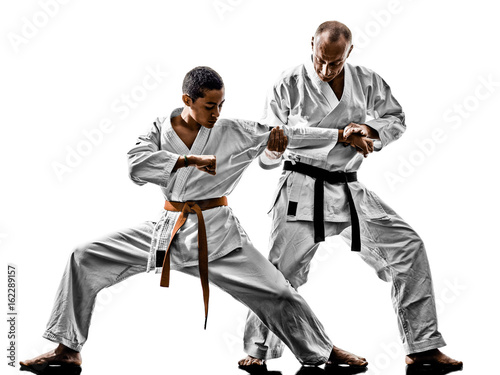two karate men sensei and teenager student teacher teaching isolated on white background