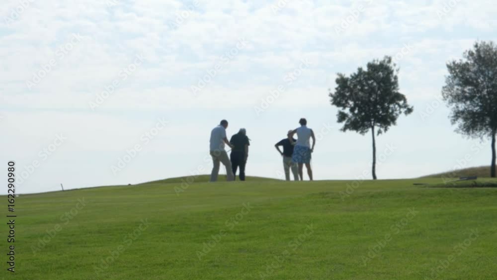 Golf players backlit high slow motion
Golf players backlit high slow motion
