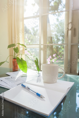 Open laptop and accessories with coffee cup for home workplace