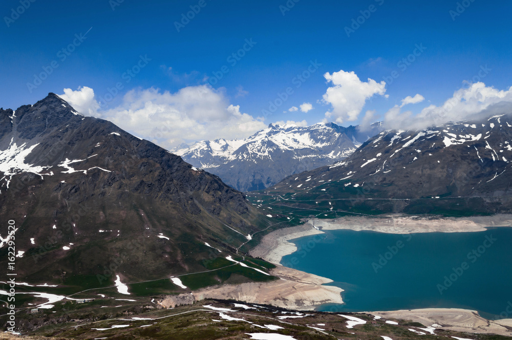 Obraz premium MontCenis Lake, France. Blue sky in a summer day. Trekking at 2400 mt and snow into the pathway