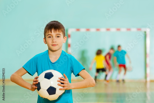Young football player ready to throw soccer ball