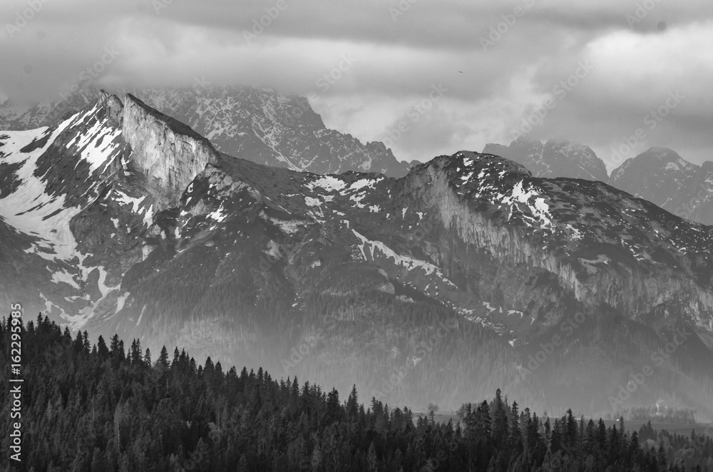 Obraz premium Cloudy Tatra mountains in the morning, covered with snow, B&W