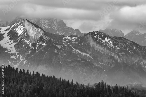 Fototapeta Naklejka Na Ścianę i Meble -  Cloudy Tatra mountains in the morning, covered with snow, B&W