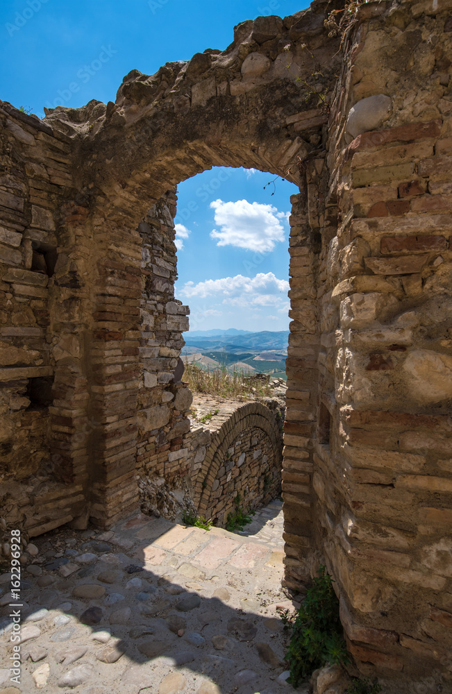 Craco (Italy) - The evocative ruins and landscapes of the ghost town scattered among the badlands hills of the Basilicata region, beside Matera, destroyed by a landslide and abandoned.