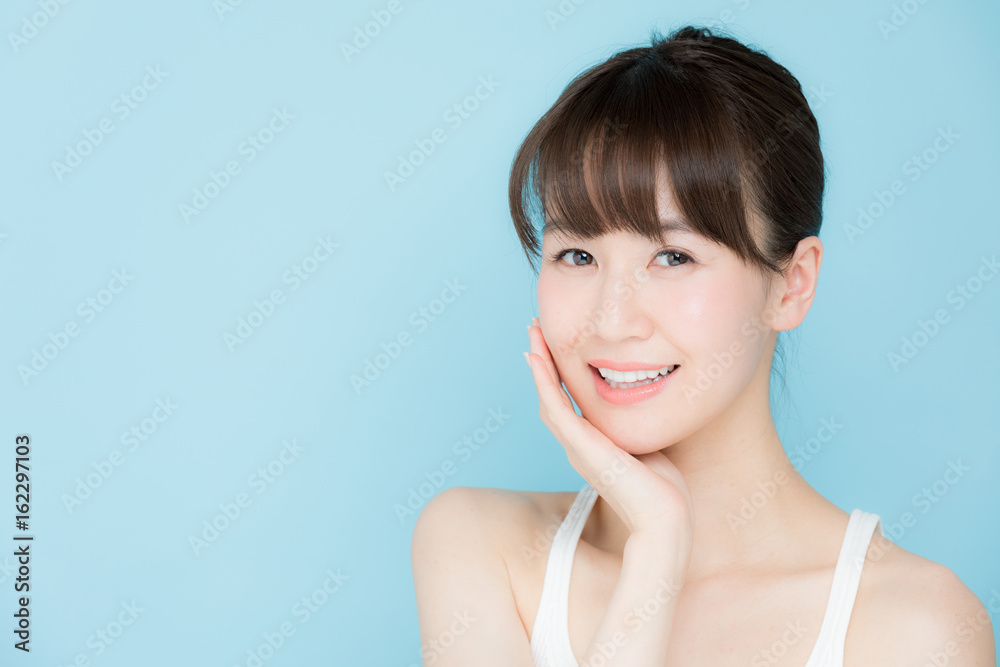 attractive asian woman beauty image on blue background attractive asian woman beauty image on blue background