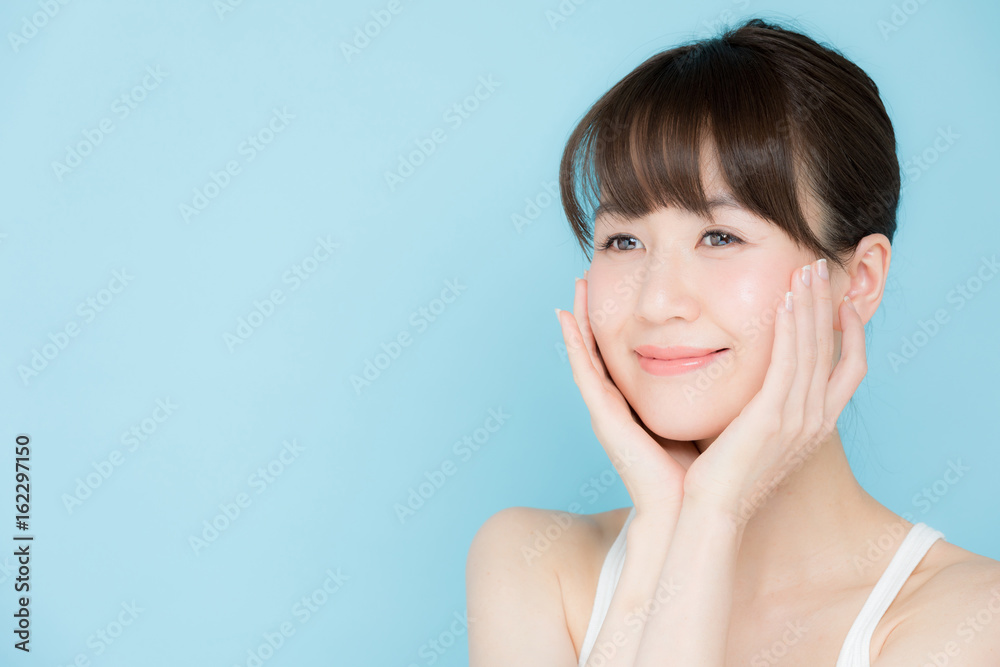 attractive asian woman beauty image on blue background attractive asian woman beauty image on blue background