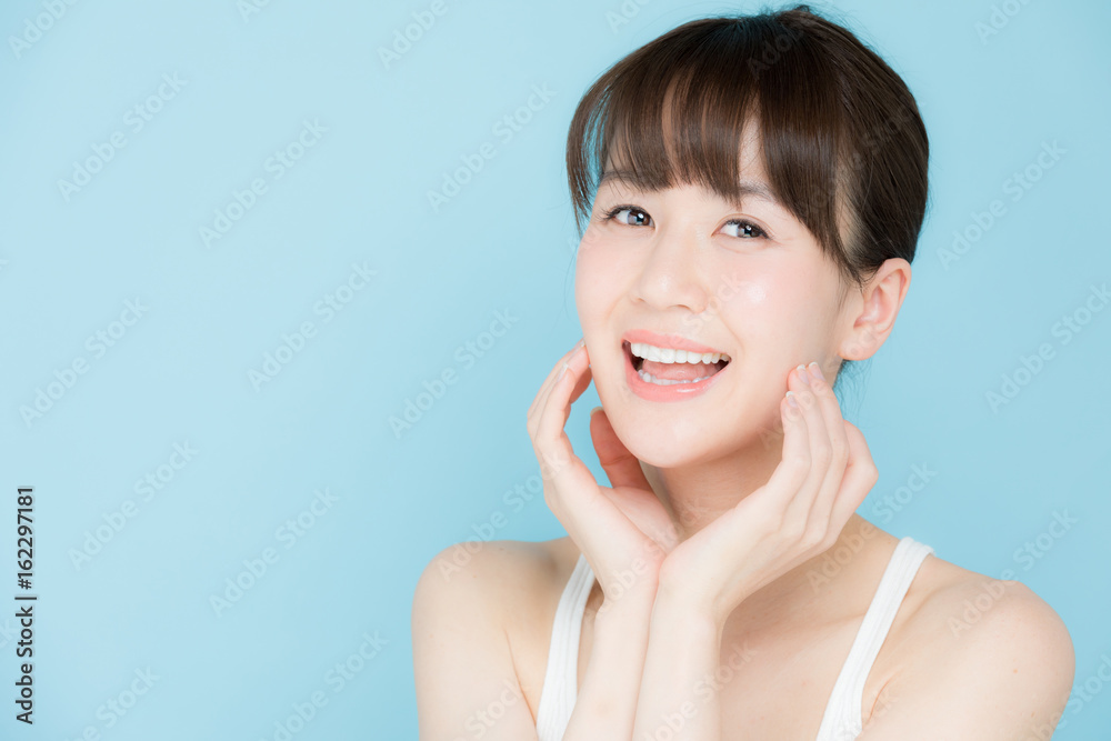 attractive asian woman beauty image on blue background attractive asian woman beauty image on blue background