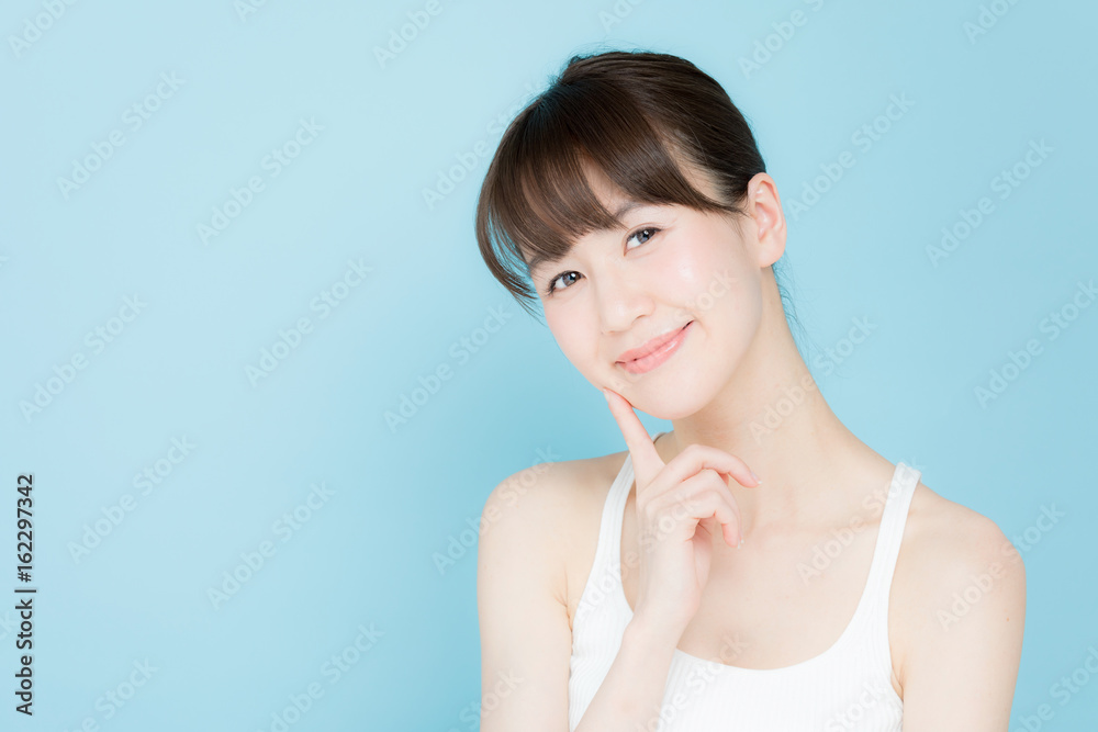 attractive asian woman beauty image on blue background attractive asian woman beauty image on blue background