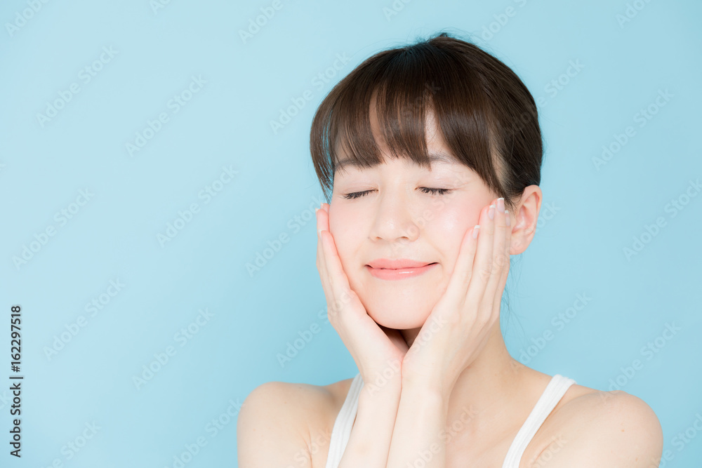 attractive asian woman beauty image on blue background attractive asian woman beauty image on blue background