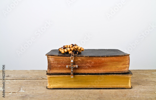 Rosary beads and books of Catholic Church liturgy photo