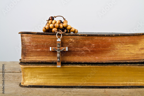 Rosary beads and books of Catholic Church liturgy photo